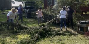 Volunteers clearing debris from the camp.