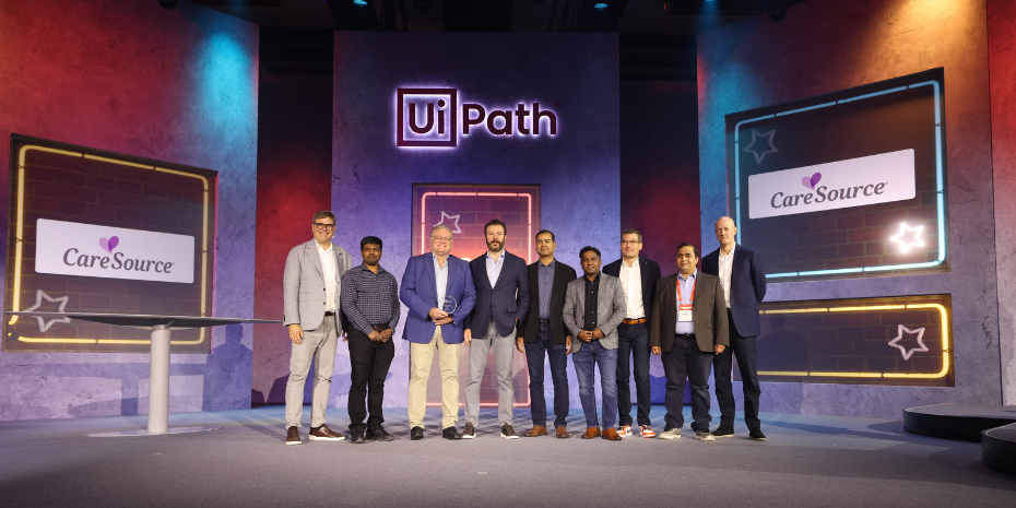 Group of people standing with an award.